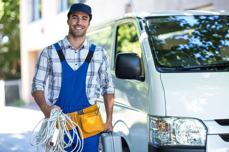 Portrait of happy HVAC technician with toolbox.